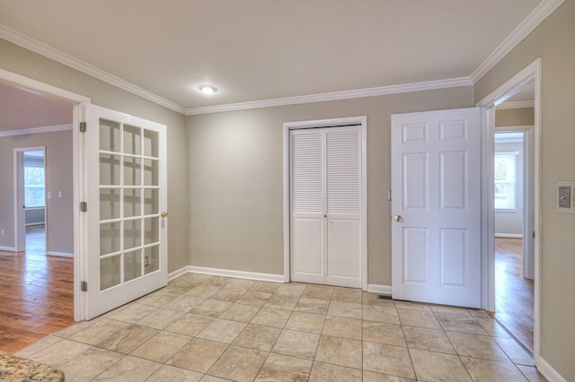 spare room with light wood-type flooring and ornamental molding