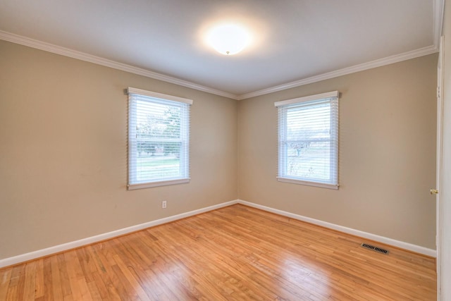 unfurnished room featuring light hardwood / wood-style flooring and ornamental molding