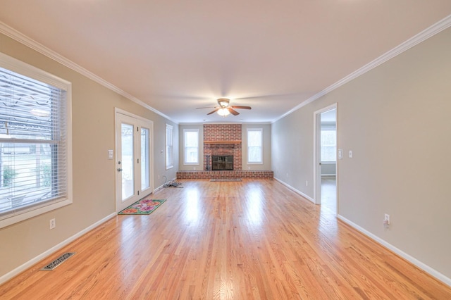 unfurnished living room with plenty of natural light, light hardwood / wood-style floors, and crown molding