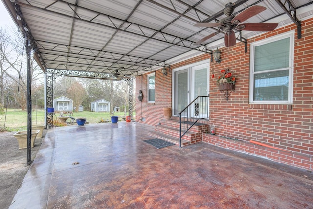 view of patio with ceiling fan and a storage shed