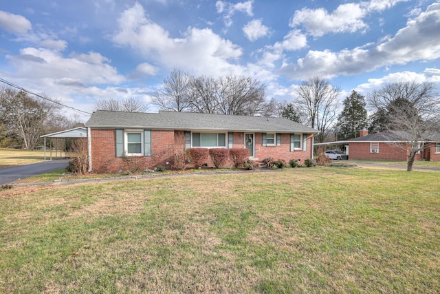 ranch-style home featuring a front yard and a carport