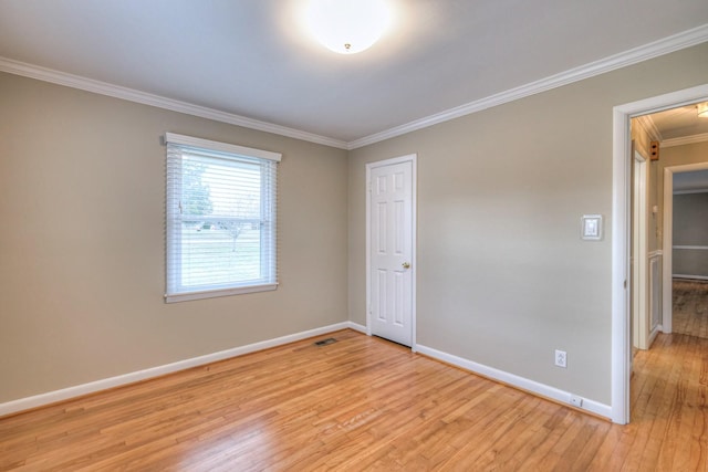 unfurnished bedroom featuring light hardwood / wood-style flooring, a closet, and ornamental molding