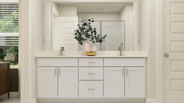 bathroom featuring vanity and an enclosed shower