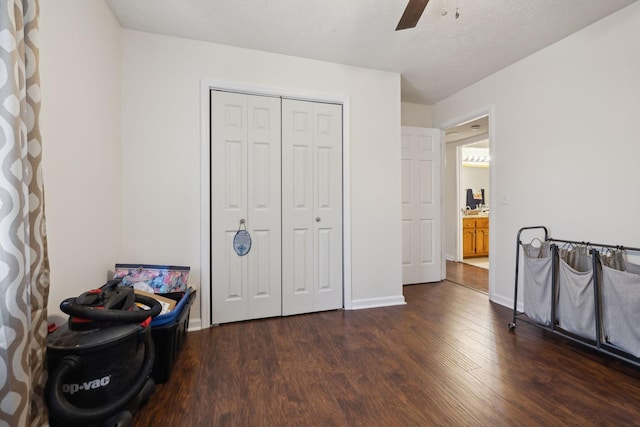 bedroom featuring a textured ceiling, ceiling fan, a closet, and dark hardwood / wood-style floors