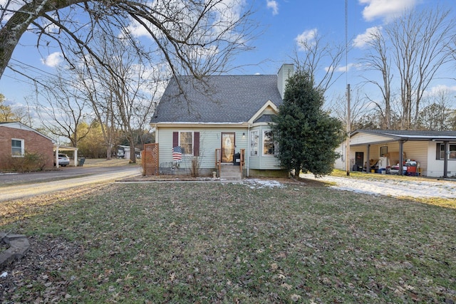 view of front of property featuring a carport and a front lawn