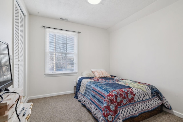 carpeted bedroom featuring a textured ceiling