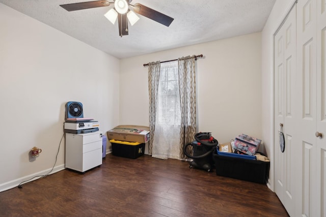 miscellaneous room with dark wood-type flooring, a textured ceiling, and ceiling fan