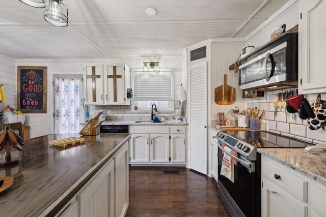 kitchen featuring white cabinets, stainless steel appliances, sink, and dark wood-type flooring