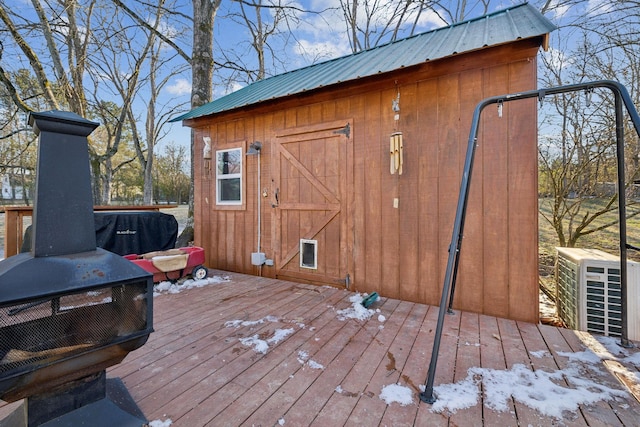 wooden terrace featuring a shed