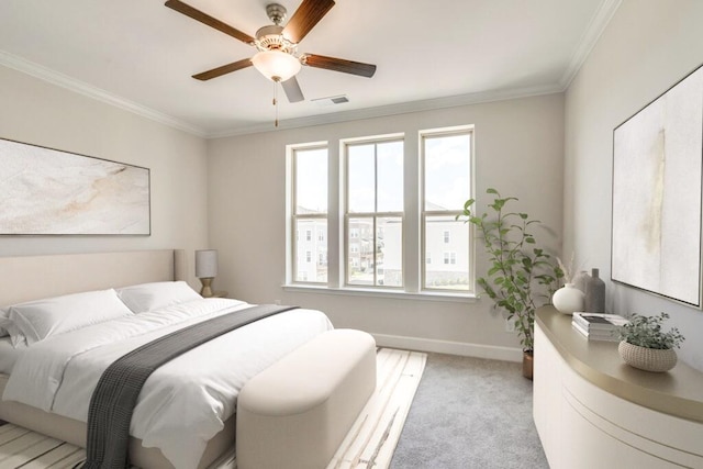 carpeted bedroom featuring ceiling fan and crown molding