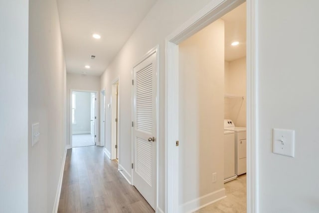 corridor featuring light hardwood / wood-style flooring and washer and clothes dryer