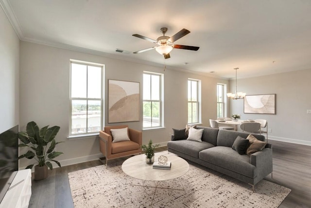 living room with dark hardwood / wood-style floors, crown molding, and ceiling fan with notable chandelier