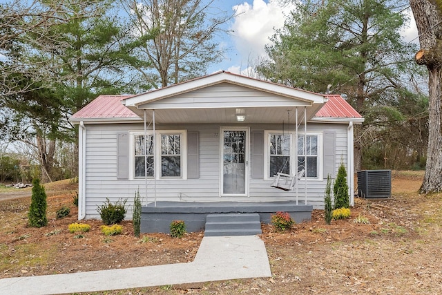 view of front of house with cooling unit and covered porch