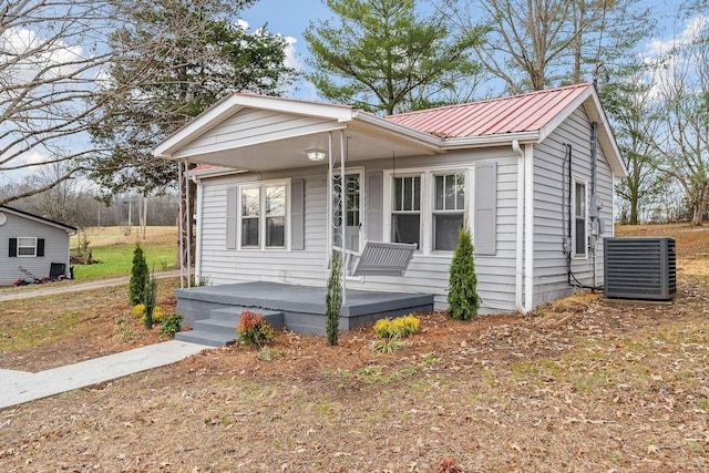 view of front of house featuring cooling unit and covered porch