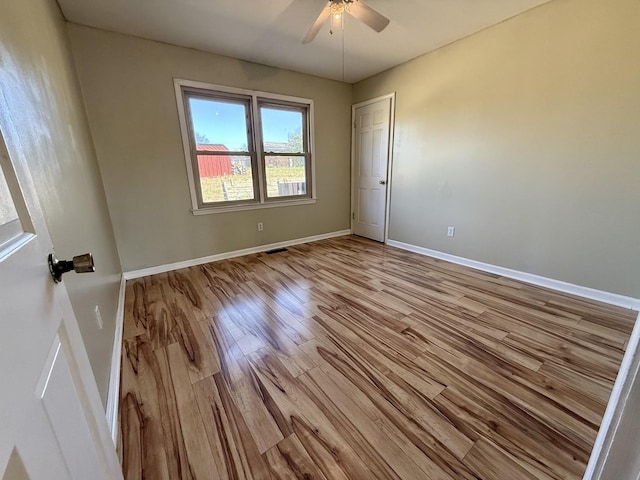 spare room with light hardwood / wood-style flooring and ceiling fan