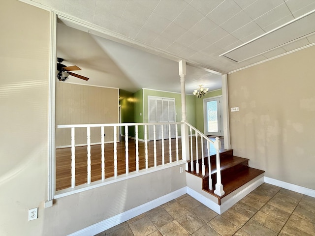 staircase featuring ceiling fan with notable chandelier