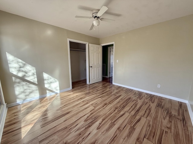 unfurnished bedroom featuring a closet, light hardwood / wood-style floors, and ceiling fan