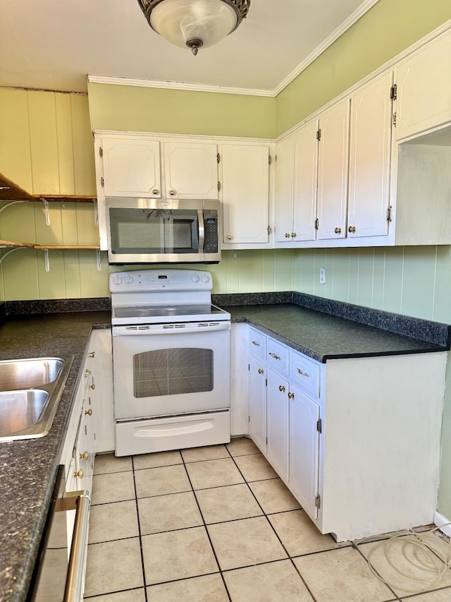 kitchen with white cabinets, light tile patterned floors, and appliances with stainless steel finishes