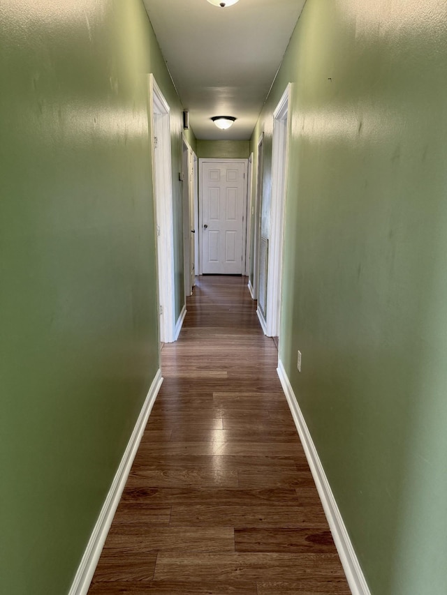 corridor with dark hardwood / wood-style floors