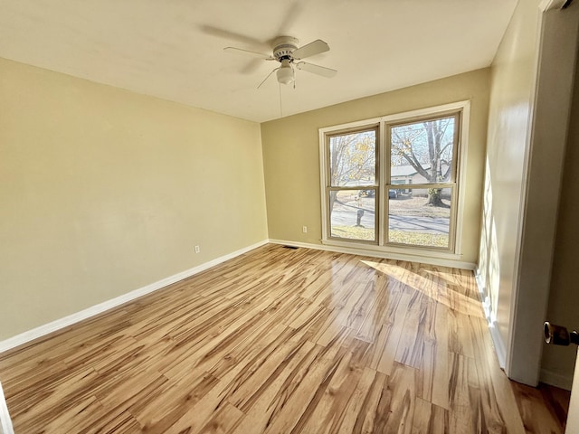 spare room featuring light hardwood / wood-style flooring and ceiling fan