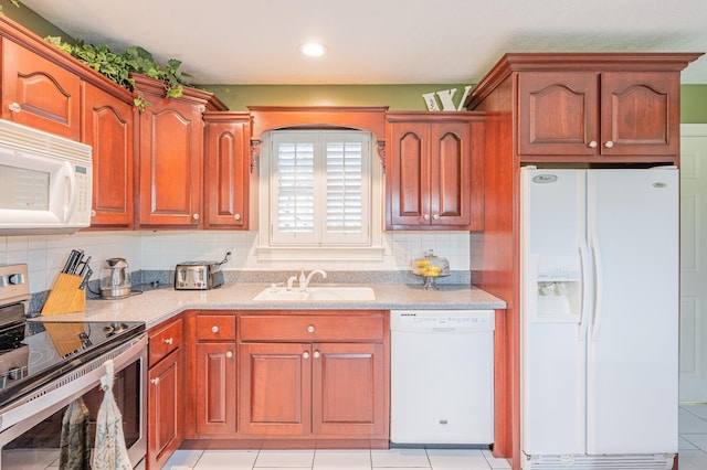 kitchen with tasteful backsplash, sink, light tile patterned flooring, and white appliances