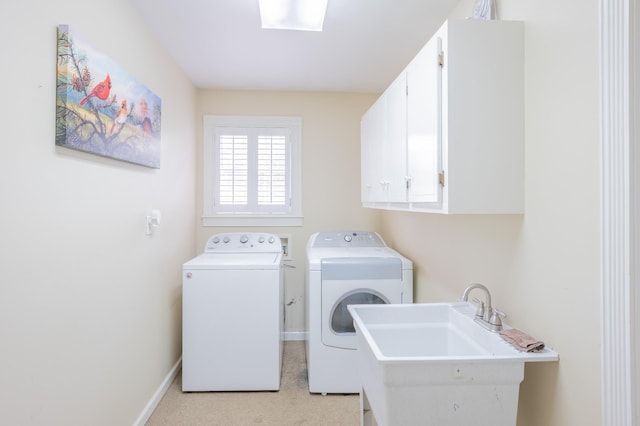 washroom featuring cabinets, sink, light colored carpet, and washing machine and clothes dryer