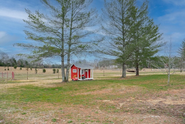 view of yard featuring a rural view and a storage shed