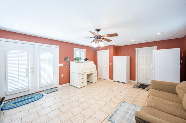 interior space featuring white cabinets, light tile patterned floors, white refrigerator, and ceiling fan