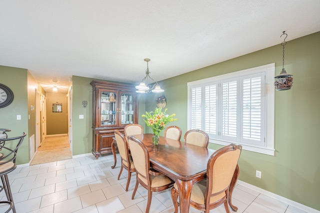 dining space featuring light tile patterned floors