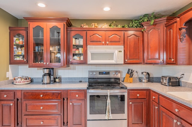 kitchen featuring backsplash and electric stove