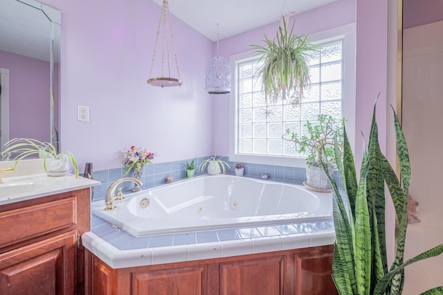 bathroom with vanity and a relaxing tiled tub