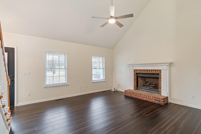 unfurnished living room with ceiling fan, high vaulted ceiling, dark hardwood / wood-style floors, and a brick fireplace