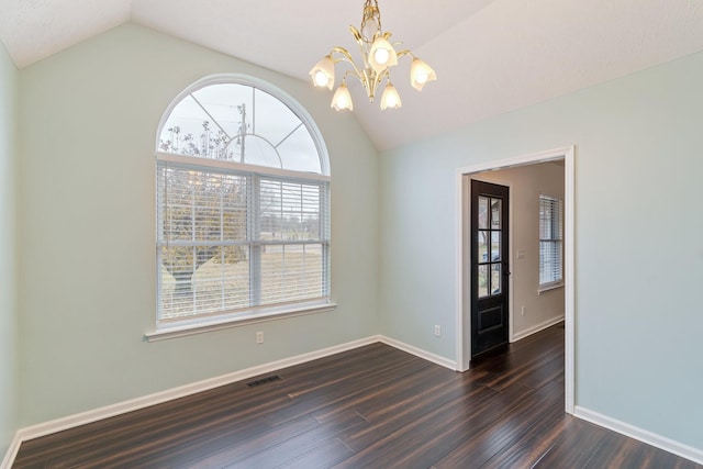 spare room with a notable chandelier, dark hardwood / wood-style floors, and lofted ceiling