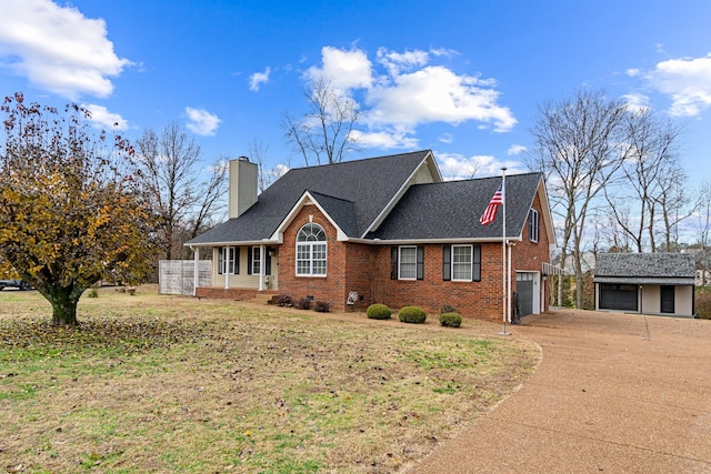 view of front of home featuring a front yard, a porch, and a garage