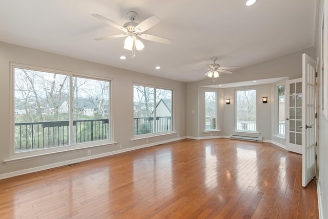 unfurnished room with light hardwood / wood-style floors, plenty of natural light, and ceiling fan