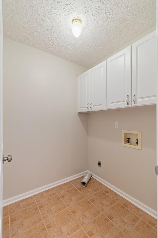 laundry area featuring cabinets, hookup for a washing machine, a textured ceiling, hookup for an electric dryer, and light tile patterned flooring