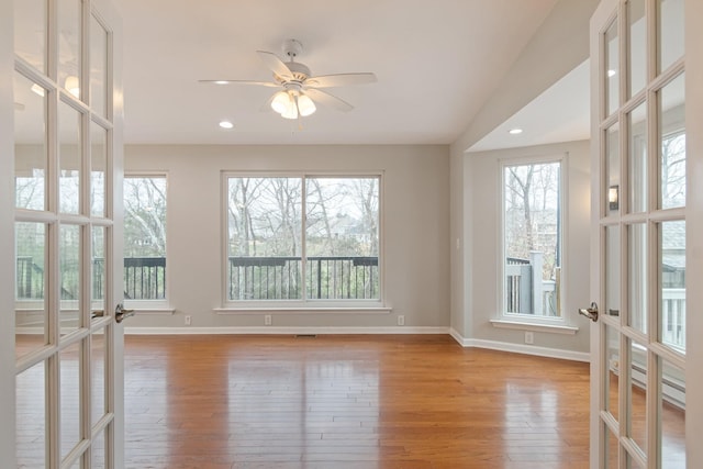 sunroom / solarium featuring ceiling fan and french doors