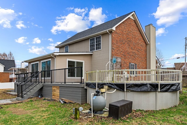 back of house with a lawn and a swimming pool side deck