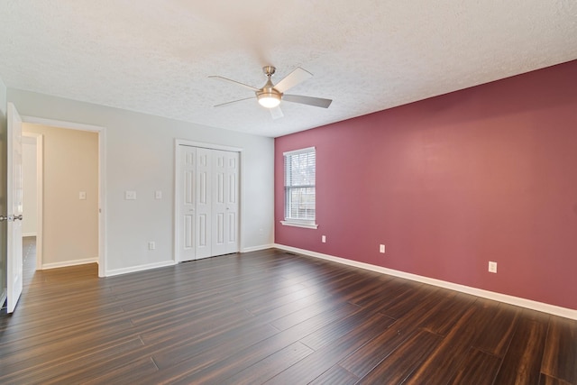 unfurnished bedroom featuring a textured ceiling, ceiling fan, a closet, and dark hardwood / wood-style floors