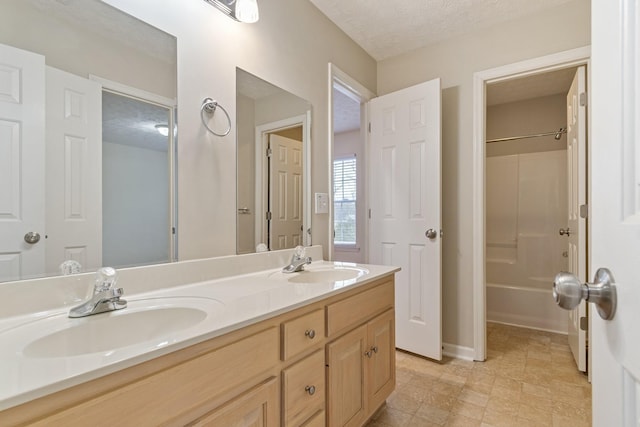 bathroom with vanity and a textured ceiling