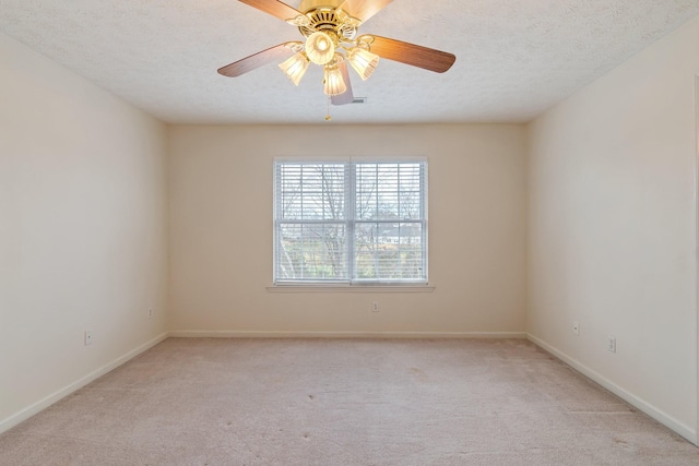 carpeted empty room featuring ceiling fan and a textured ceiling