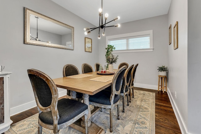 dining room with a notable chandelier and dark hardwood / wood-style flooring