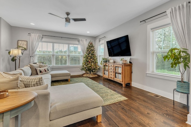 living room featuring dark hardwood / wood-style floors and ceiling fan