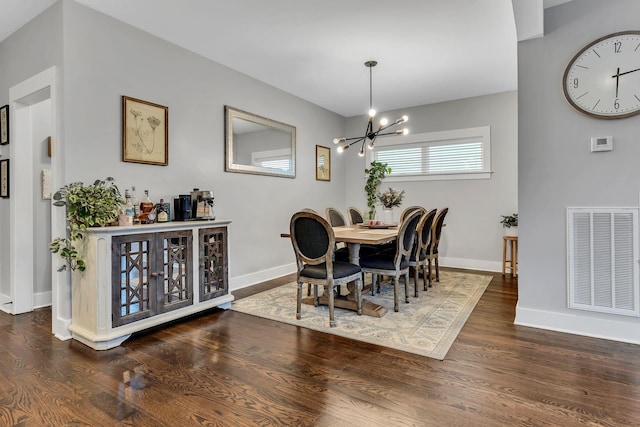 dining space featuring a chandelier and dark hardwood / wood-style floors