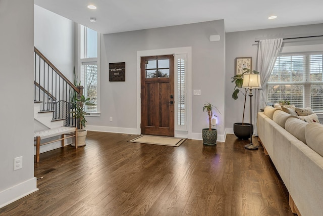 entryway featuring a wealth of natural light and dark hardwood / wood-style floors