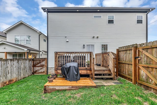 back of house with a yard and a deck