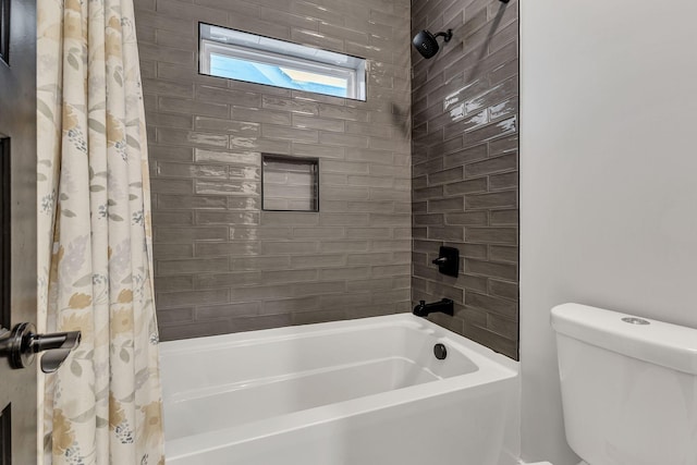 bathroom featuring shower / bathtub combination with curtain and toilet