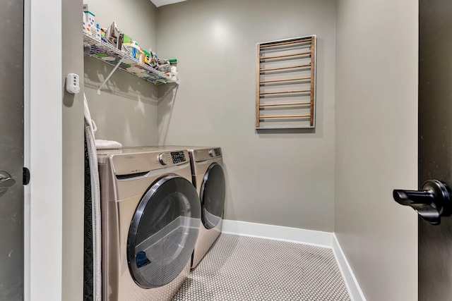 clothes washing area with tile patterned floors and washing machine and clothes dryer