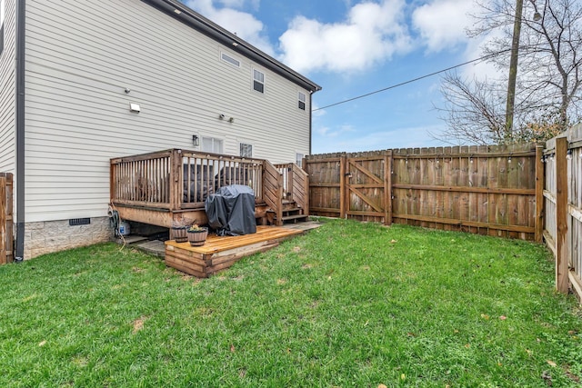 rear view of property with a lawn and a wooden deck