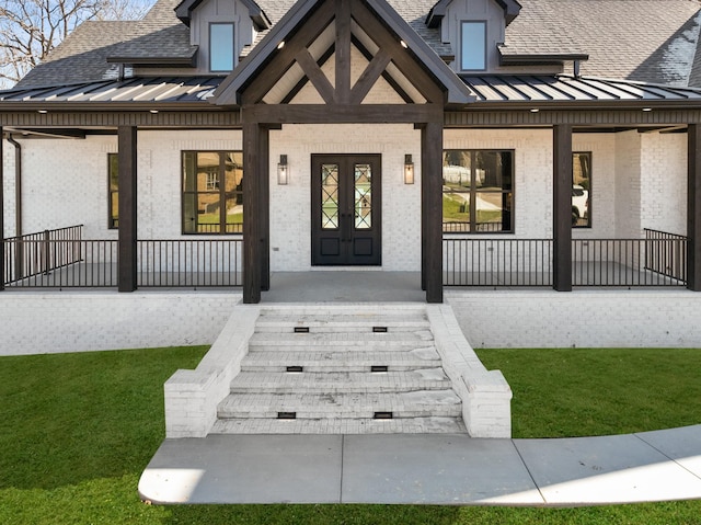 view of exterior entry with a porch